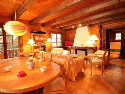 a dining room and living room with a table and chairs at Chalet 4 chambres sur pistes débutants avec balcon et parking, à 350m des commerces - FR-1-572-196 in Arâches-la-Frasse