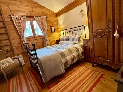 a bedroom with a bed in a wooden room at 4 pièces 6 pers : proche spa, ski bus, parking, WIFI - FR-1-572-119 in Arâches-la-Frasse