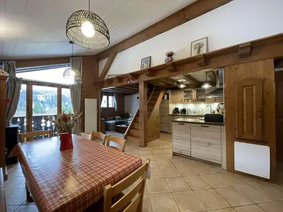 a kitchen and dining room with a table and chairs at 4 pièces 6 pers : proche spa, ski bus, parking, WIFI - FR-1-572-119 in Arâches-la-Frasse