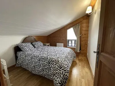 a bedroom with a bed in a small room at 4 pièces 6 pers : proche spa, ski bus, parking, WIFI - FR-1-572-119 in Arâches-la-Frasse
