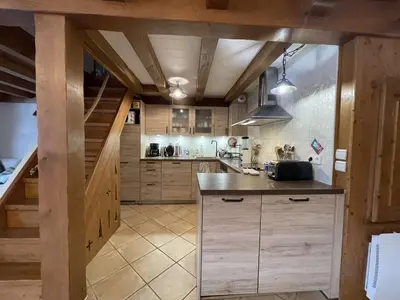 a kitchen with wooden cabinets and a counter top at 4 pièces 6 pers : proche spa, ski bus, parking, WIFI - FR-1-572-119 in Arâches-la-Frasse
