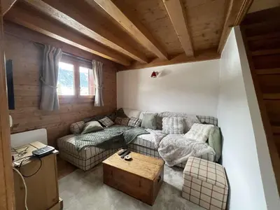 a living room with a couch and a table at 4 pièces 6 pers : proche spa, ski bus, parking, WIFI - FR-1-572-119 in Arâches-la-Frasse