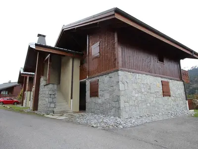 a small building with a stone and wood at 4 pièces 6 pers : proche spa, ski bus, parking, WIFI - FR-1-572-119 in Arâches-la-Frasse