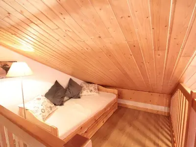 a small bed in a room with a wooden ceiling at Appartement Rénové 6/8 Pers, Pied des Pistes, Balcon, Garage, WiFi - Arâches-la-Frasse - FR-1-572-139 in Arâches-la-Frasse