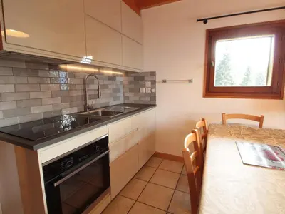 a kitchen with a sink and a stove and a table at Appartement Rénové 6/8 Pers, Pied des Pistes, Balcon, Garage, WiFi - Arâches-la-Frasse - FR-1-572-139 in Arâches-la-Frasse