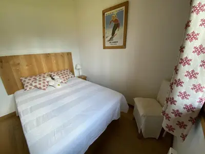 a bedroom with a white bed and a chair at Appartement Rénové 6/8 Pers, Pied des Pistes, Balcon, Garage, WiFi - Arâches-la-Frasse - FR-1-572-139 in Arâches-la-Frasse