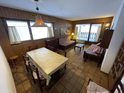 an overhead view of a living room with a table and chairs at Ski aux pieds, 2 pièces rénové, 5 couchages, terrasse, parking, proche commerces et services - FR-1-572-145 in Arâches-la-Frasse