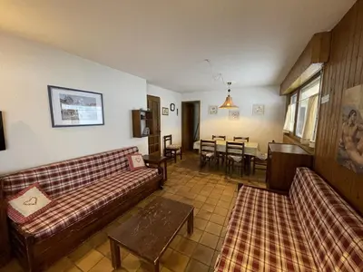 a living room with two couches and a table at Ski aux pieds, 2 pièces rénové, 5 couchages, terrasse, parking, proche commerces et services - FR-1-572-145 in Arâches-la-Frasse