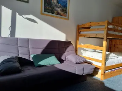 a living room with a couch and a bunk bed at Studio idéal pour l'hiver au pied des pistes - FR-1-687-112 in Arâches-la-Frasse