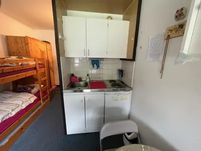 a small kitchen with a sink and a bed at Studio idéal pour l'hiver au pied des pistes - FR-1-687-112 in Arâches-la-Frasse