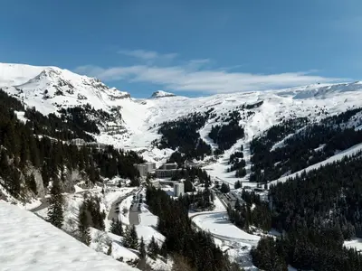a snow covered mountain with trees and a ski slope at Studio idéal pour l'hiver au pied des pistes - FR-1-687-112 in Arâches-la-Frasse