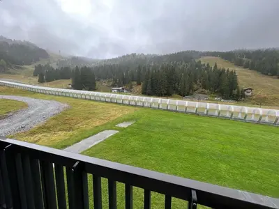 a view from a balcony of a field and a road at Studio idéal pour l'hiver au pied des pistes - FR-1-687-112 in Arâches-la-Frasse