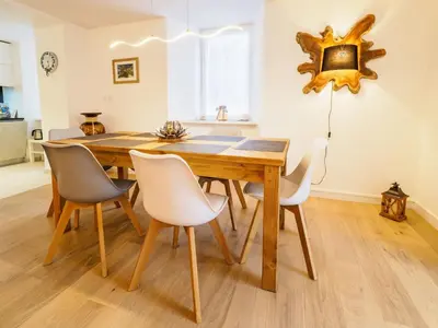 a dining room with a wooden table and chairs at DIFY Clos des Roches - Chamonix in Chamonix-Mont-Blanc