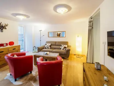 a living room with a couch and a table at DIFY Clos des Roches - Chamonix in Chamonix-Mont-Blanc