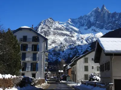 a street in a town with snow covered mountains at DIFY Clos des Roches - Chamonix in Chamonix-Mont-Blanc