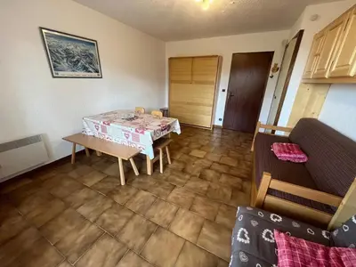 a living room with a table and a couch at Studio 4 pers avec lave-linge, pied des pistes et parking couvert à Arâches-la-Frasse - FR-1-572-266 in Arâches-la-Frasse