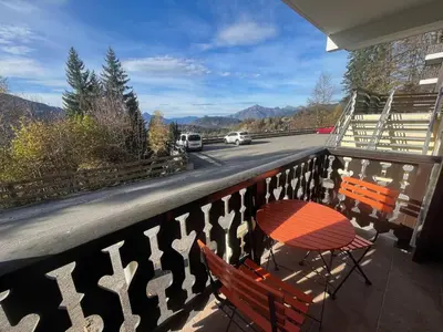 a table and chairs on a balcony with a view of a road at Studio 4 pers avec lave-linge, pied des pistes et parking couvert à Arâches-la-Frasse - FR-1-572-266 in Arâches-la-Frasse