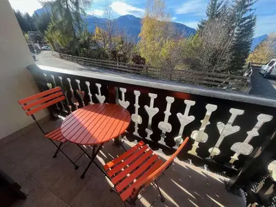 a table and two chairs on a balcony with a view at Studio 4 pers avec lave-linge, pied des pistes et parking couvert à Arâches-la-Frasse - FR-1-572-266 in Arâches-la-Frasse
