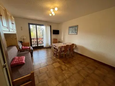a living room with a table and a couch at Studio 4 pers avec lave-linge, pied des pistes et parking couvert à Arâches-la-Frasse - FR-1-572-266 in Arâches-la-Frasse