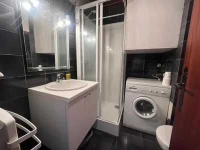 a bathroom with a sink and a washing machine at Studio 4 pers avec lave-linge, pied des pistes et parking couvert à Arâches-la-Frasse - FR-1-572-266 in Arâches-la-Frasse