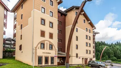 a tall building with a street light next to it at Les Sitelles - 11 - Piscine Appart 6 pers in Morillon