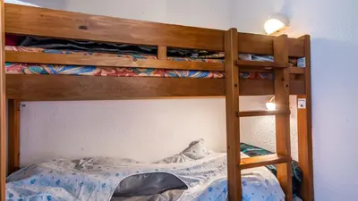 a bunk bed with a ladder to the top bunk at Les Sitelles - 18 - Belle vue Appart 6 pers in Morillon
