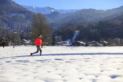 a man running in the snow with a frisbee at Grand Morillon - 104 - Montagne Belle Vue Studio 4 in Morillon