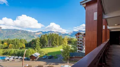 a balcony of a hotel with a view of the mountains at Les Eterlous - 39- Appart pied des pistes 6 pers in Morillon