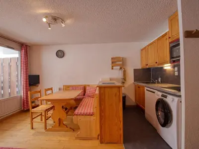 a kitchen with a wooden table and a table and a washing machine at Appartement confortable 6 pers. pied des pistes à Morillon - FR-1-642-79 in Morillon