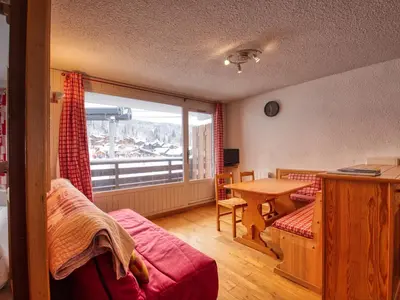 a living room with a table and a large window at Appartement confortable 6 pers. pied des pistes à Morillon - FR-1-642-79 in Morillon