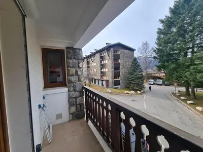 a balcony with a view of a building at Spacieux 2 pièces + cabine, idéal famille, 5 pers, centre village, proche commerces et pistes - FR-1-572-156 in Arâches-la-Frasse