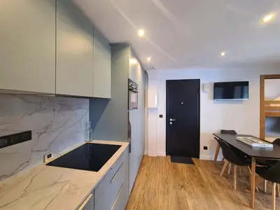 a kitchen with a table and a dining room at Spacieux 2 pièces + cabine, idéal famille, 5 pers, centre village, proche commerces et pistes - FR-1-572-156 in Arâches-la-Frasse