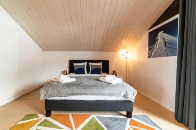 a bedroom with a bed with a wooden ceiling at Chalet Genepi - spectacular ski and summer home in Saint-Gervais-les-Bains