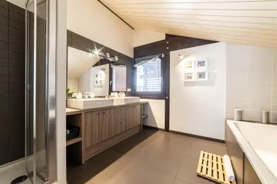 a bathroom with a sink and a mirror at Chalet Genepi - spectacular ski and summer home in Saint-Gervais-les-Bains