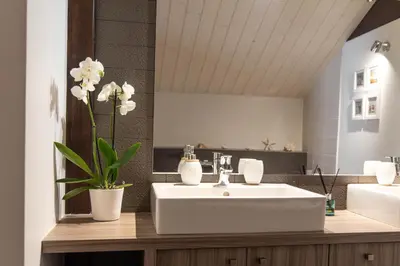 a bathroom with a white sink and a mirror at Chalet Genepi - spectacular ski and summer home in Saint-Gervais-les-Bains