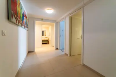 a hallway with white walls and a tile floor at Chalet Genepi - spectacular ski and summer home in Saint-Gervais-les-Bains