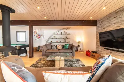 a living room with two couches and a tv at Chalet Genepi - spectacular ski and summer home in Saint-Gervais-les-Bains
