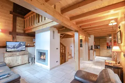 a log cabin in the snow with mountains in the background at Family chalet with terrace and garden in Chamonix in Chamonix-Mont-Blanc