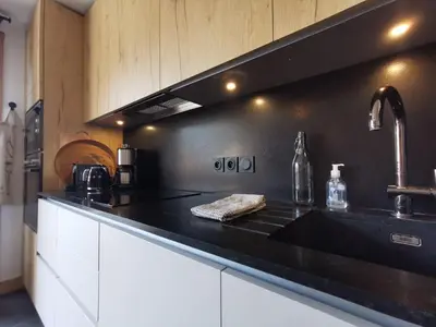a kitchen with a black counter top and a sink at Terra Losa - Tout Nouveau - Centre des Houches - Point de Départ et D'arrivée TMB in Les Houches