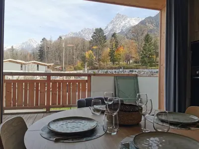 a table with wine glasses and a view of the mountains at Terra Losa - Tout Nouveau - Centre des Houches - Point de Départ et D'arrivée TMB in Les Houches