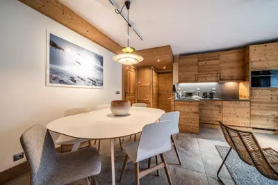 a kitchen and dining room with a table and chairs at Apartment Valvisons Les Houches Chamonix - by EMERALD STAY in Les Houches