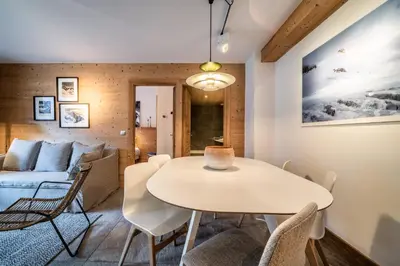 a living room with a table and a couch at Apartment Valvisons Les Houches Chamonix - by EMERALD STAY in Les Houches