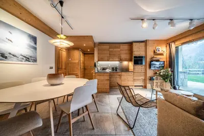 a kitchen and dining room with a table and chairs at Apartment Valvisons Les Houches Chamonix - by EMERALD STAY in Les Houches