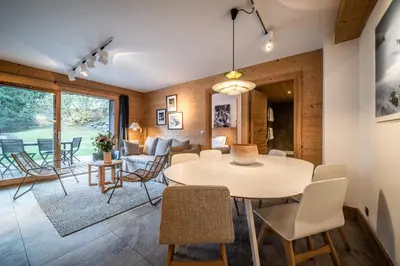 a dining room and living room with a table and chairs at Apartment Valvisons Les Houches Chamonix - by EMERALD STAY in Les Houches