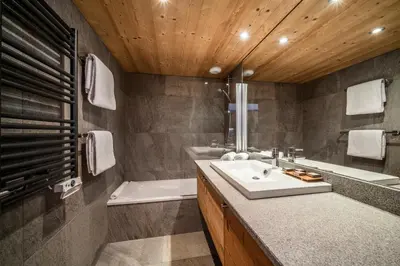 a bathroom with a sink and a bath tub and a tub at Apartment Valvisons Les Houches Chamonix - by EMERALD STAY in Les Houches