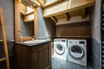 a bathroom with a washing machine and a sink at Delys - Renovated - Beside Park - Climbing wall - Hikes - Mont-Blanc views in Les Houches