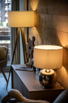 a table with two lamps on top of it at Apartment Cortirion Megeve - by EMERALD STAY in Megève