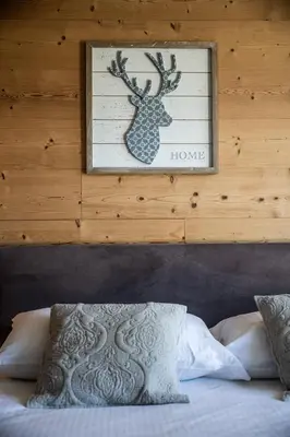 a picture of a deer on the wall above a bed at Apartment Cortirion Megeve - by EMERALD STAY in Megève