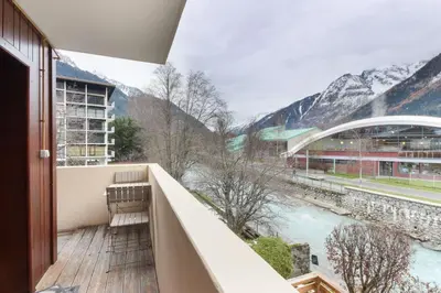 a bedroom with a bed with a striped blanket at Perce-Neige - Centre Chamonix in Chamonix-Mont-Blanc