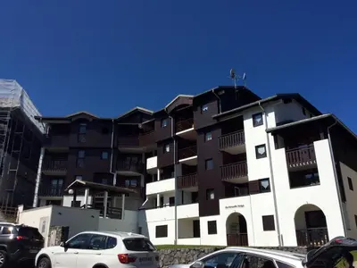 a living room with a couch and a kitchen at Appartement cosy à Morillon - 6 pers, internet - FR-1-815-90 in Morillon